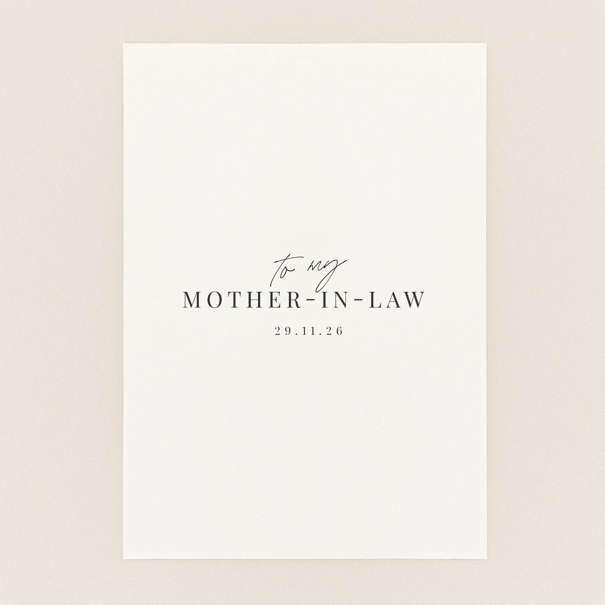A minimalist white square card or print with elegant black text reading 'to my MOTHER-IN-LAW' and the date.