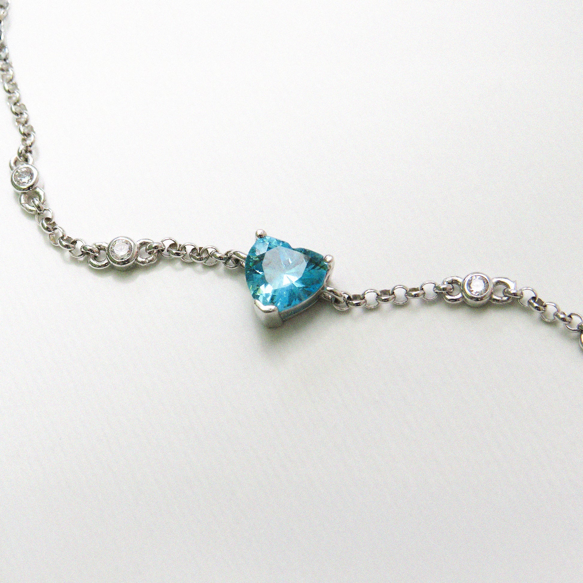 Silver bracelet with a heart-shaped blue gemstone