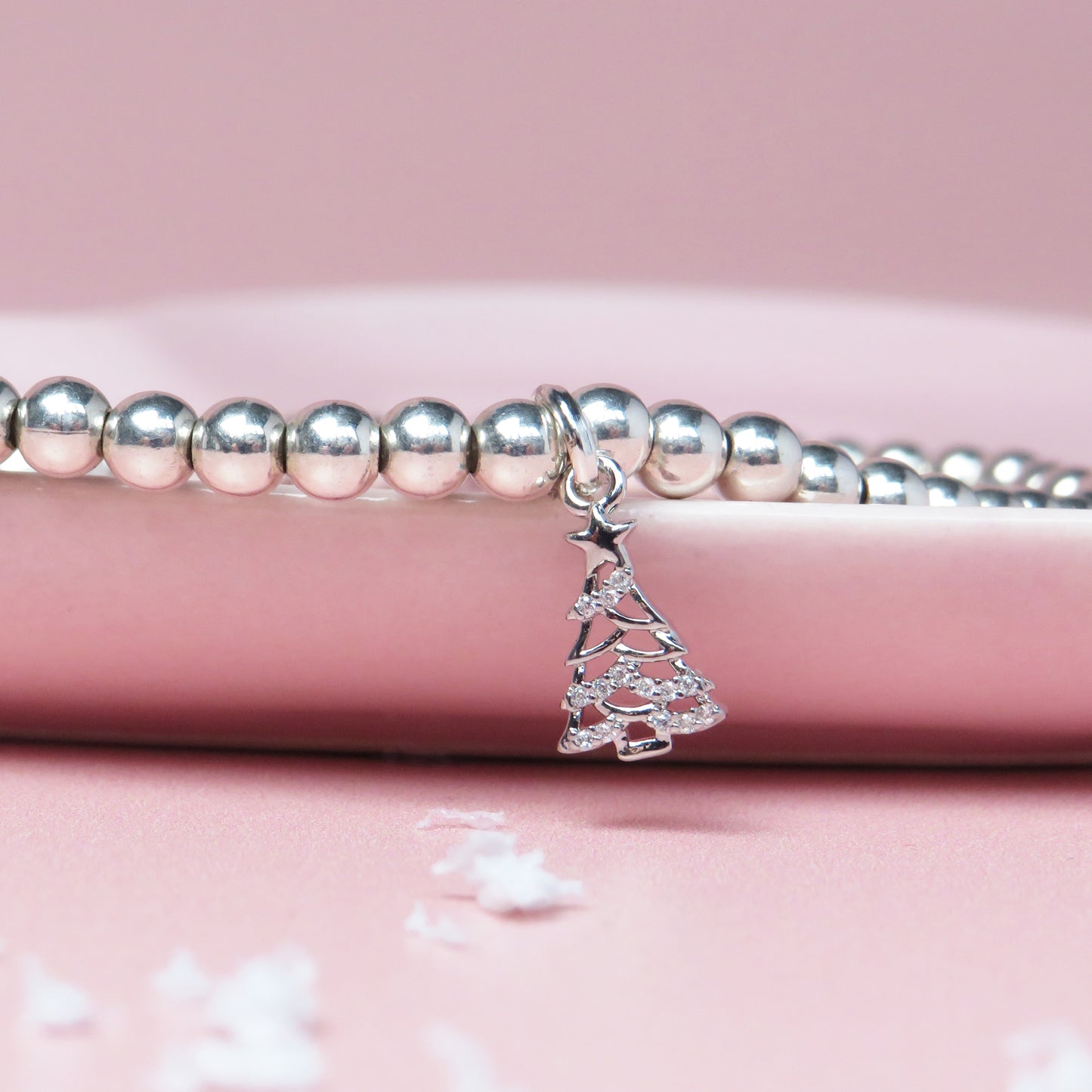 Silver-plated Christmas tree charm bracelet on a festive "Tree-mendous Christmas" card with holiday tree and gift illustrations, ideal for Christmas gifts and stocking fillers.