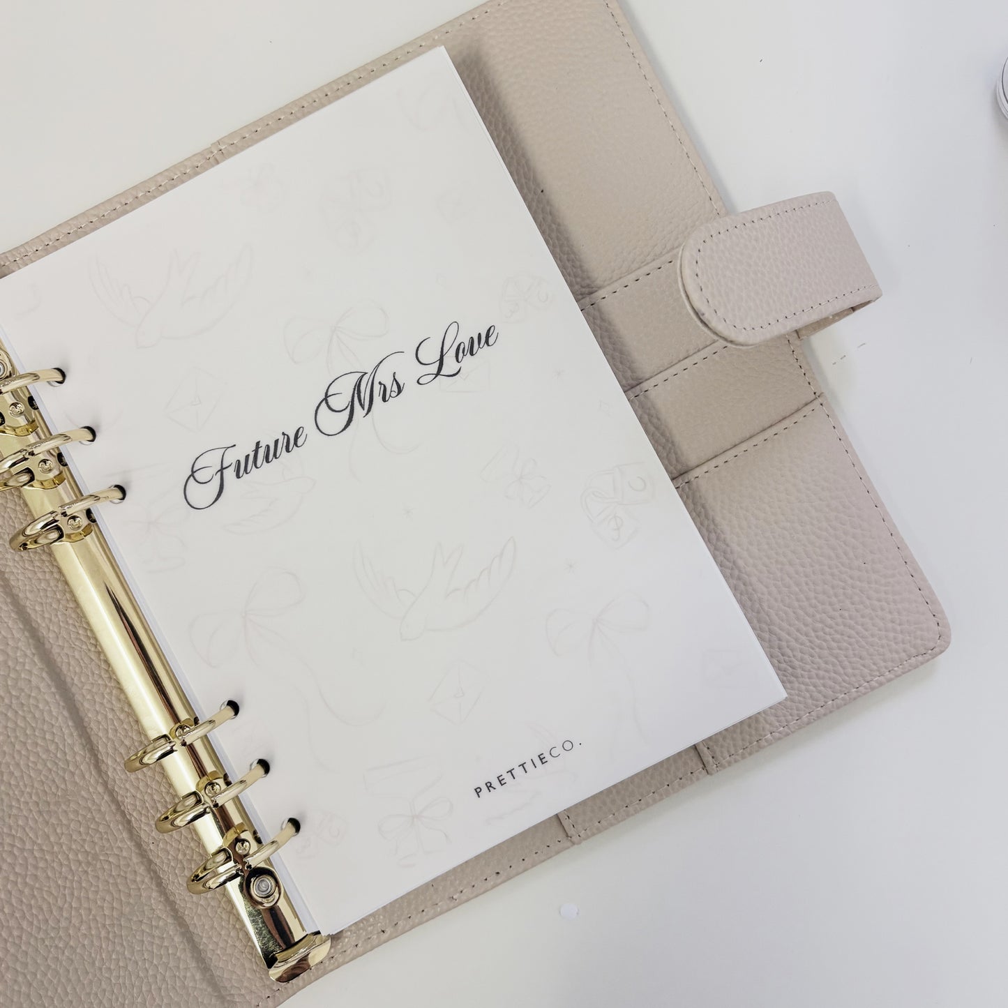 Beige planner with a white card inside reading 'Future Mrs". Perfect engagement gift.