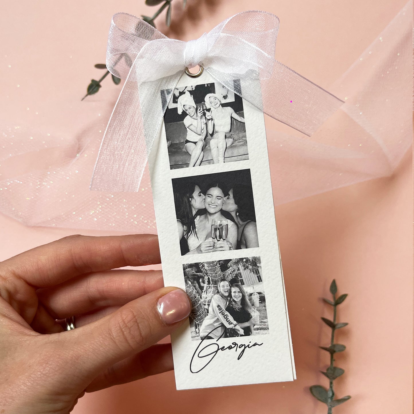 Woman's Hand holding the Personalised luxury bridesmaid proposal or thank you card with black and white photos and white organza ribbon. 