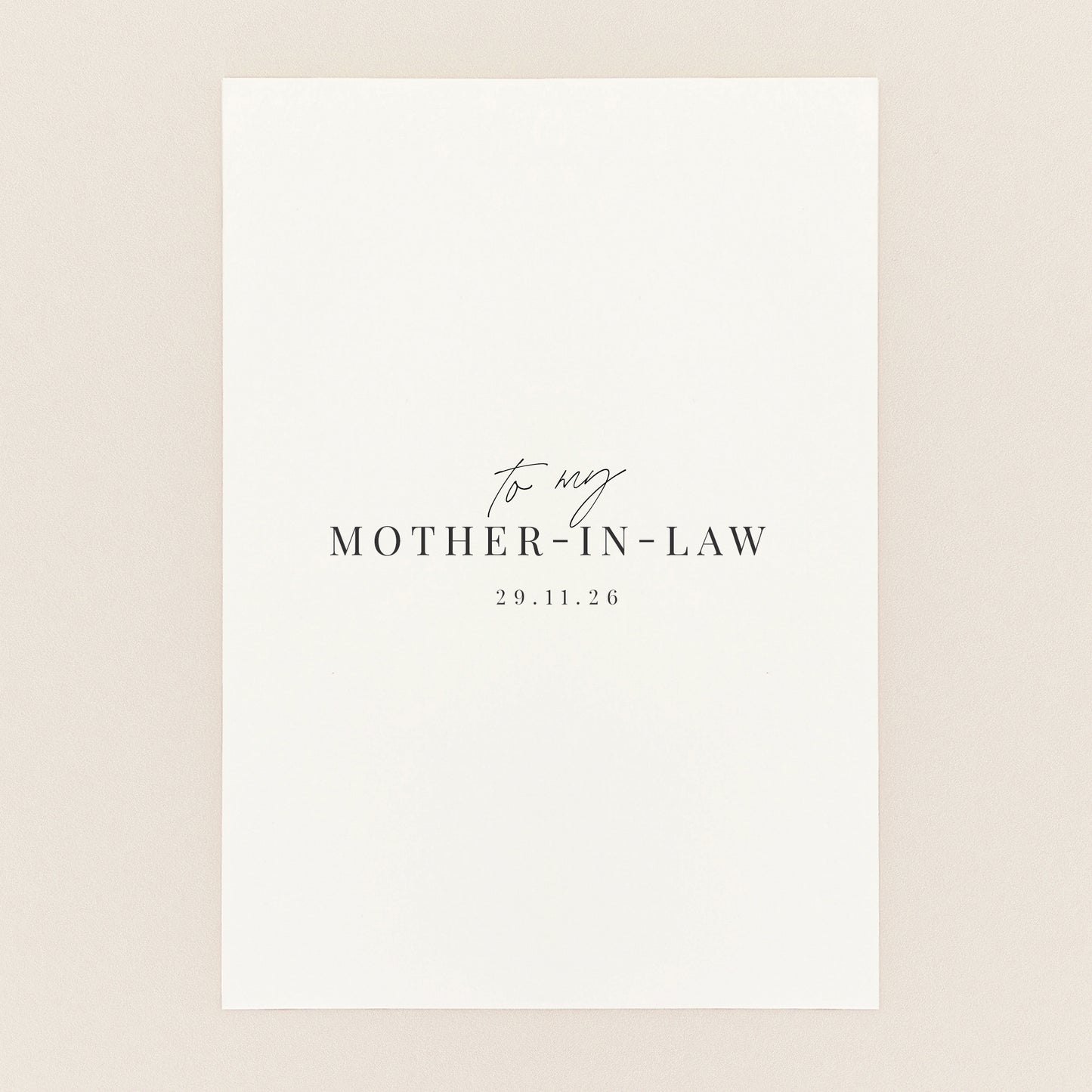 A minimalist white square card or print with elegant black text reading 'to my MOTHER-IN-LAW' and the date.