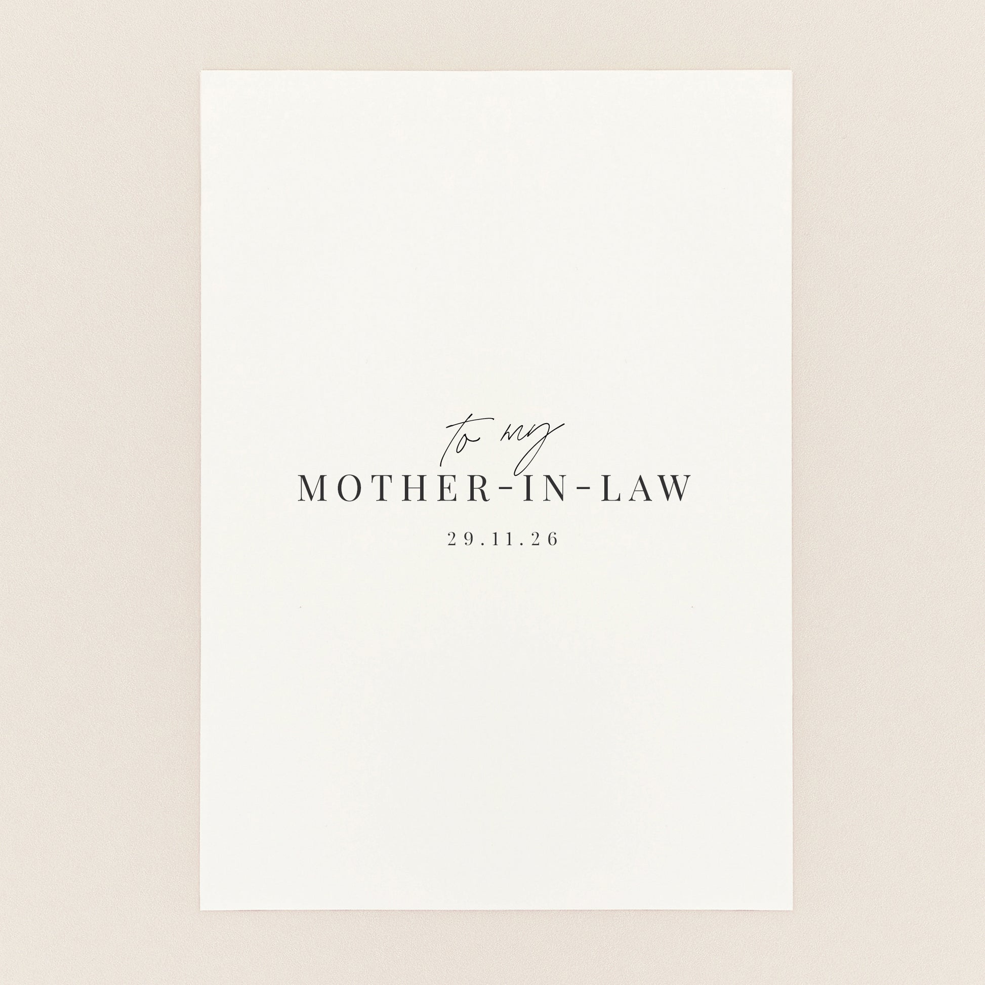A minimalist white square card or print with elegant black text reading 'to my MOTHER-IN-LAW' and the date.