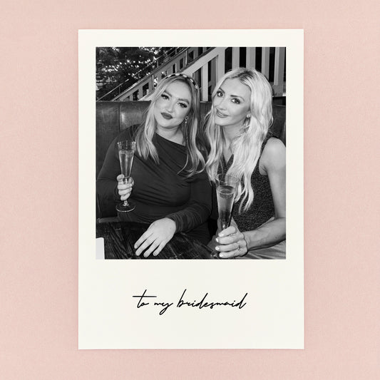 Two women holding champagne glasses with text 'to my bridesmaid' on a pink background